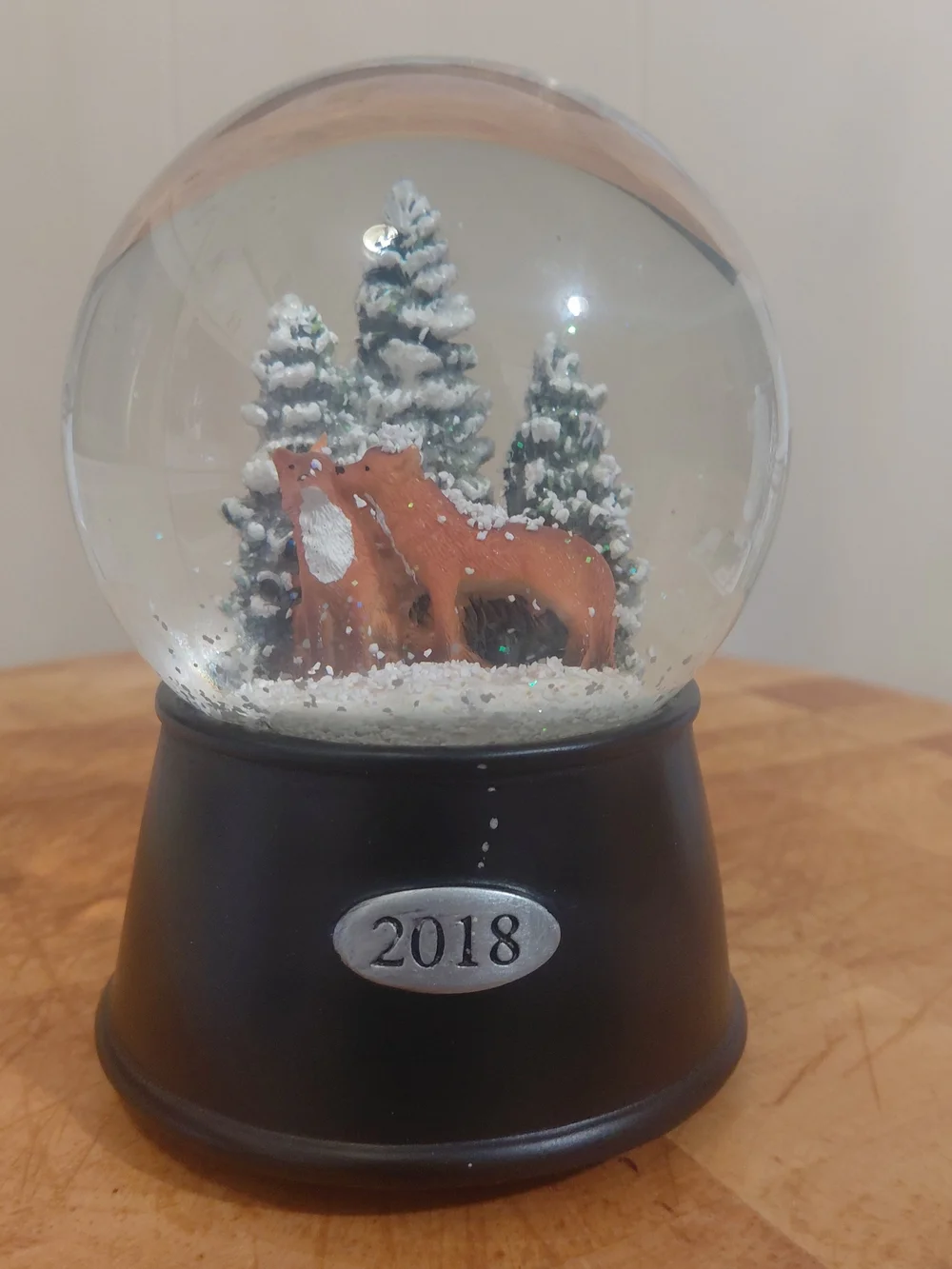 2018 Holiday Fox Snow Globe in Brown and Green with Black Base